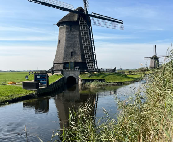 Maaike your local tourguide  wearing Dutch wooden shoes. Windmill, Tulips, Cheese, Zaanse Schans, Keukenhof, Volendam, Marken, Alkmaar.