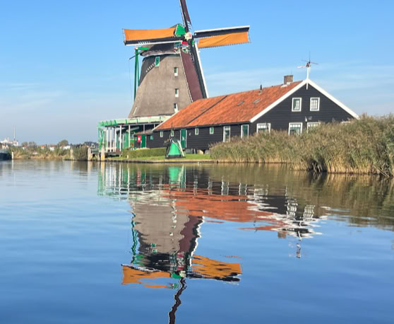 Maaike your local tourguide  wearing Dutch wooden shoes. Windmill, Tulips, Cheese, Zaanse Schans, Keukenhof, Volendam, Marken, Alkmaar.