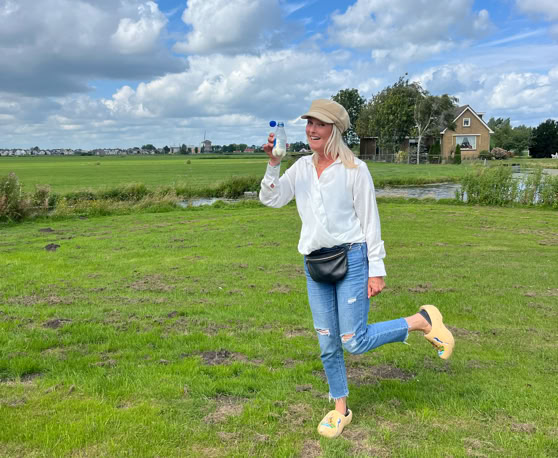 Maaike your local tourguide  wearing Dutch wooden shoes. Windmill, Tulips, Cheese, Zaanse Schans, Keukenhof, Volendam, Marken, Alkmaar.