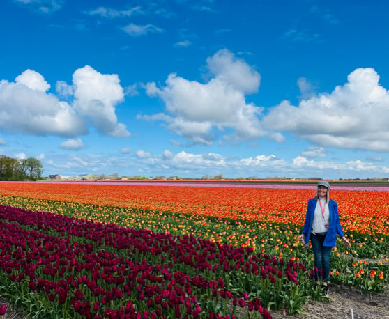 Maaike your local tourguide  wearing Dutch wooden shoes. Windmill, Tulips, Cheese, Zaanse Schans, Keukenhof, Volendam, Marken, Alkmaar.