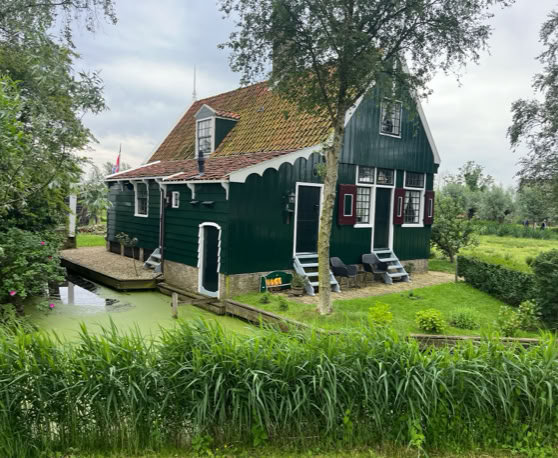 Maaike your local tourguide  wearing Dutch wooden shoes. Windmill, Tulips, Cheese, Zaanse Schans, Keukenhof, Volendam, Marken, Alkmaar.